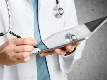 Doctor checking on a tablet patient's notes