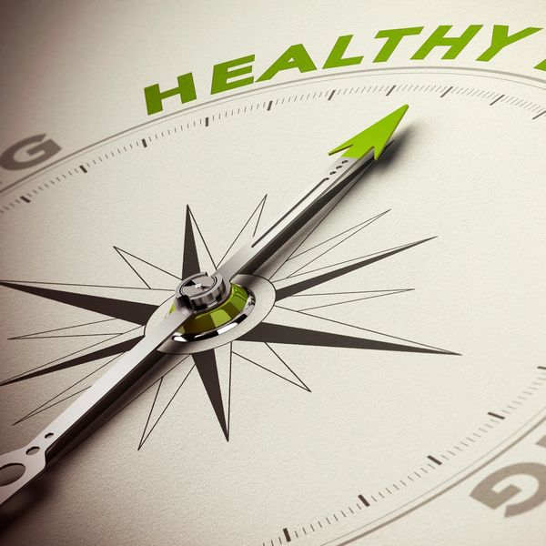 Compass needle pointing towards 'Healthy' in bright green.