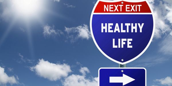 A next exit sign with the words healthy life and an arrow pointing in the right direction.