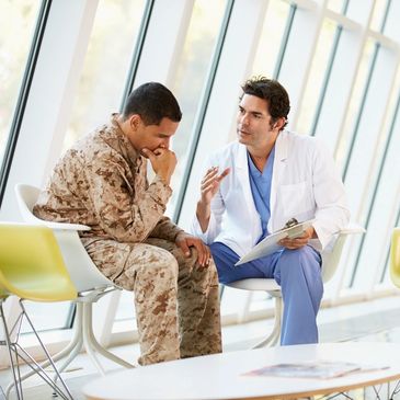 A doctor talks to a soldier in a modern medical facility.