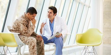 A doctor counseling a soldier in a medical facility.