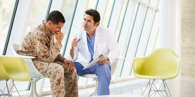 A doctor talking to a military