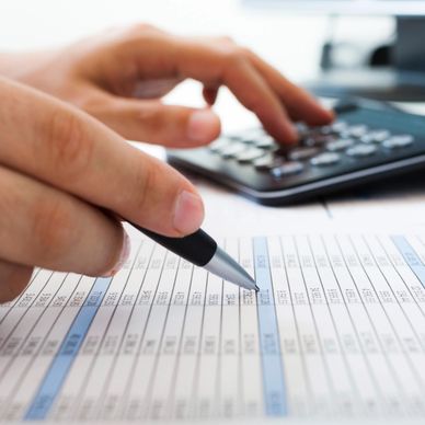 Person working on financial spreadsheet