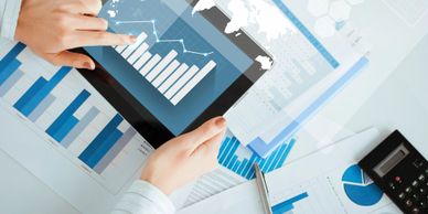 Tablet and paperwork with data graphs in focus