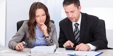 Two business people sitting on a table and discussing 