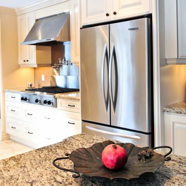 Modern kitchen with granite countertops and stainless steel appliances.