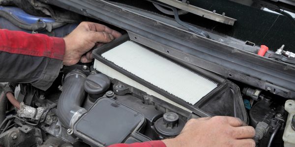 Technician replacing air filter.