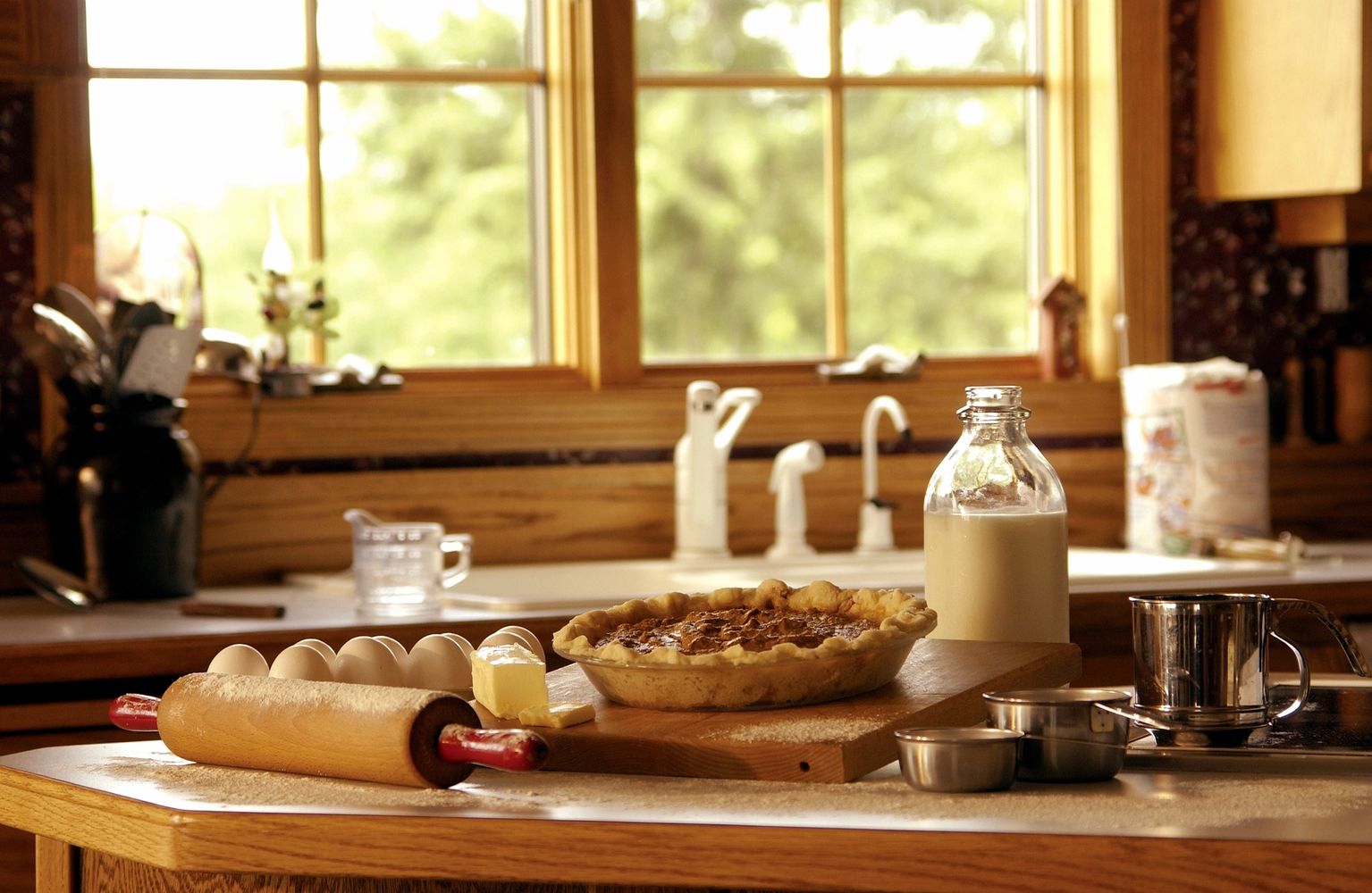 A cozy kitchen scene with freshly baked pie and baking ingredients.