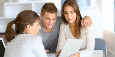 Woman discussing information with a young couple