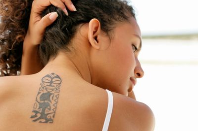 A person’s back with a tattoo