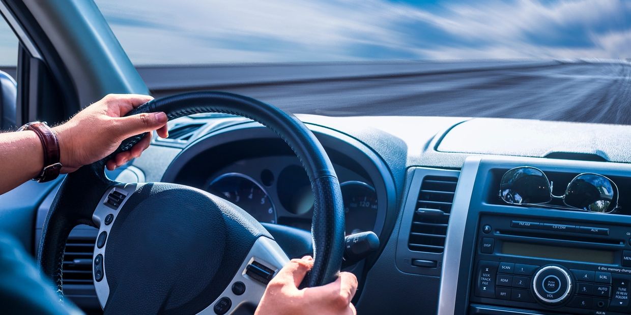 Car is driving with a clear windshield that is not dirty as a result of GlassParency