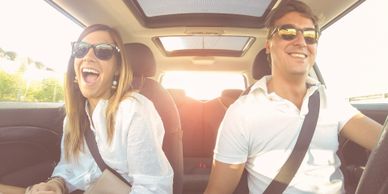 two vehicle occupants having fun in a vehicle