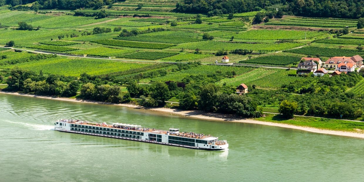 Ship cruising down river. AmaWaterways, Viking river, UniWorld. 