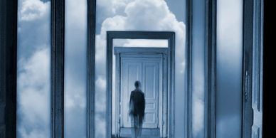 A person standing in a surreal hallway with multiple door frames and cloudy sky.