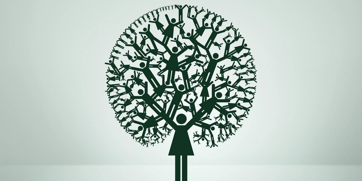 Tree formed by interconnected human figures symbolizing unity and growth.