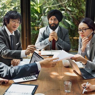 Diverse business team collaborating around a wooden table.