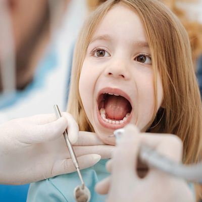 Dentist examining child's mouth