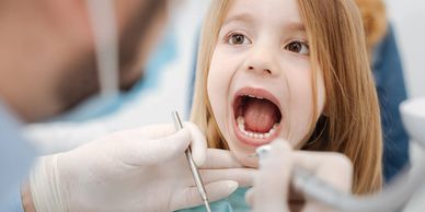 child with mouth open for dental work