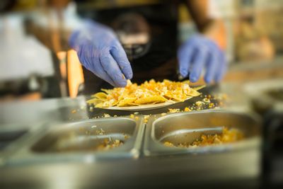 Nachos on a plate getting ready to serve.