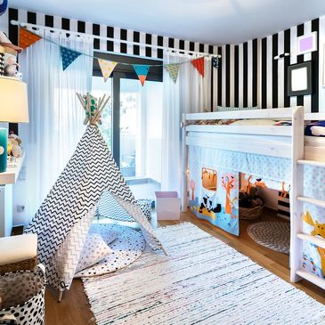 Bright children's bedroom with a teepee and loft bed.