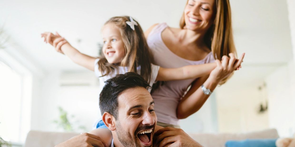 A happy family with husband, wife and little girl.