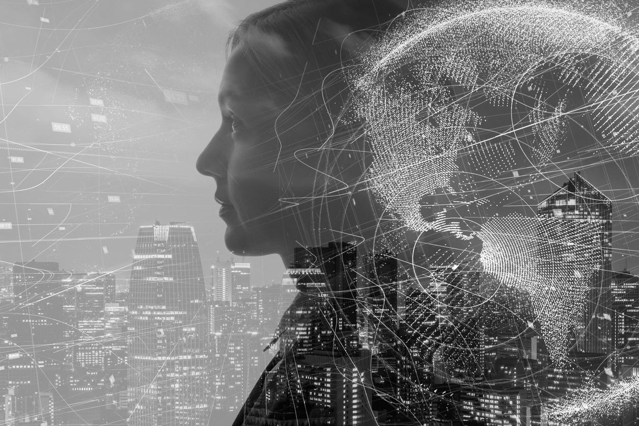Double exposure of a woman's profile with a cityscape and digital globe overlay.