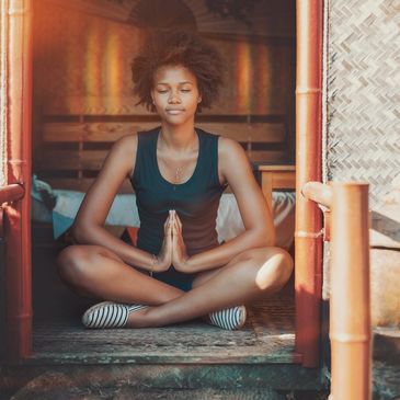 African woman meditating on the floor