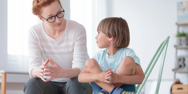 European, Bilingual nanny talking with a 6-year-old boy whom she cares for after school 