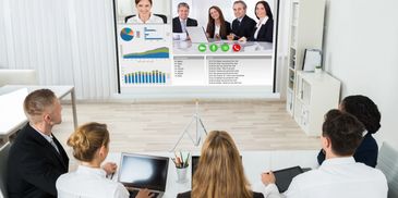 Business team attending a video conference with charts and graphs.