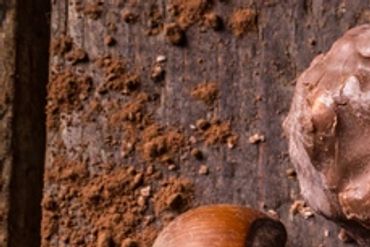 Close-up of chocolate and powdered cocoa on a wooden surface.