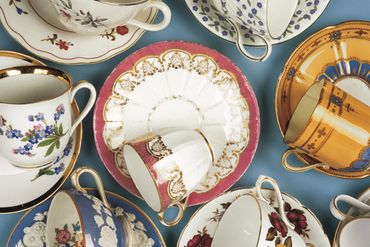 A colorful picture of vintage porcelain china teacups and saucers.