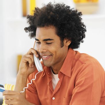 Man on telephone holding a credit card