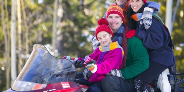 family on a snowmobile.  