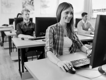 Students working on computers in a classroom setting.