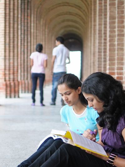 Students studying is a corridor