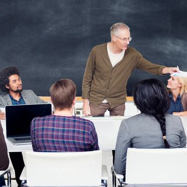 professional education for teachers - showing several adults in a lecture setting