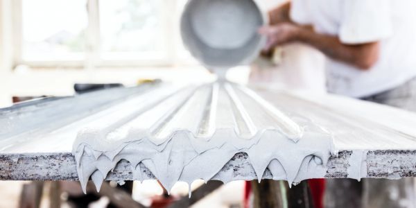 Pouring plaster or cement on a mold.