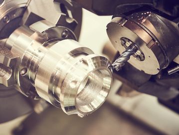Close-up of CNC machine cutting a metal piece.