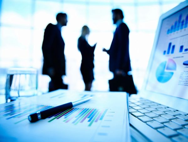 Business meeting with charts and discussions in a modern office.