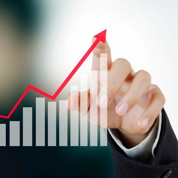 Hand pointing to an upward graph.