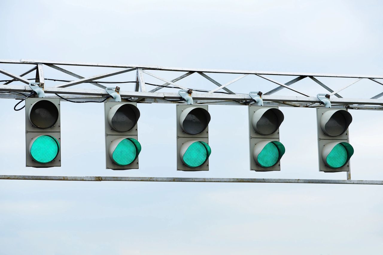 All green lights for every five lanes at the car race track.