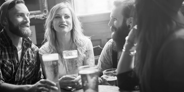 group of people sitting around a table talking 