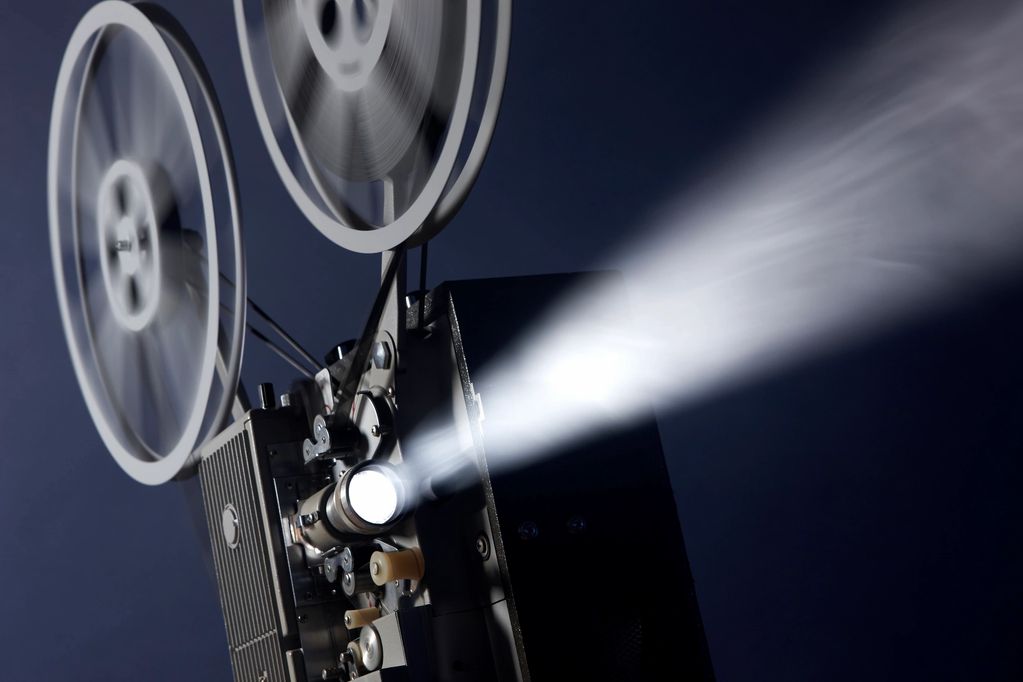 Retro film projector showing light beam.