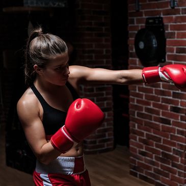 A woman boxing in a gym