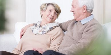 Happy mature couple sitting on sofa