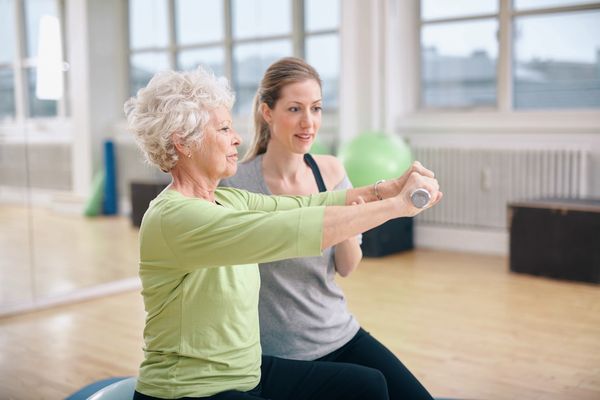 Pilates trainer working with a client one on one.