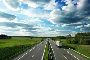 delivery truck making a delivery of ogleby sisters soap on highway with beautiful blue sky and clouds