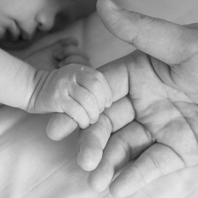 newborn baby holding their parent's finger
