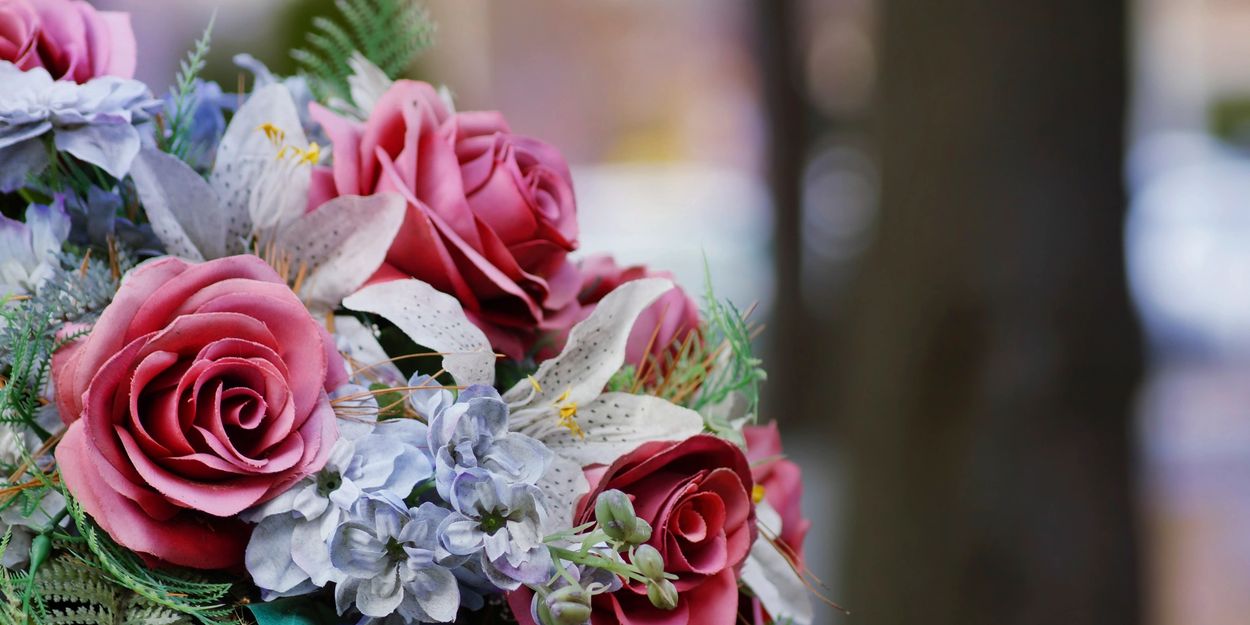 Close-up of a bouquet with pink roses and white lilies.