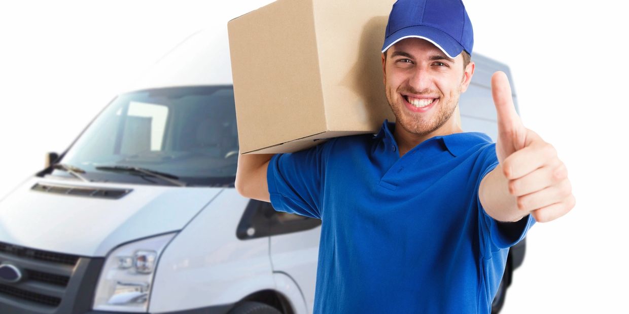 Delivery man in blue uniform holding a package and giving thumbs up.